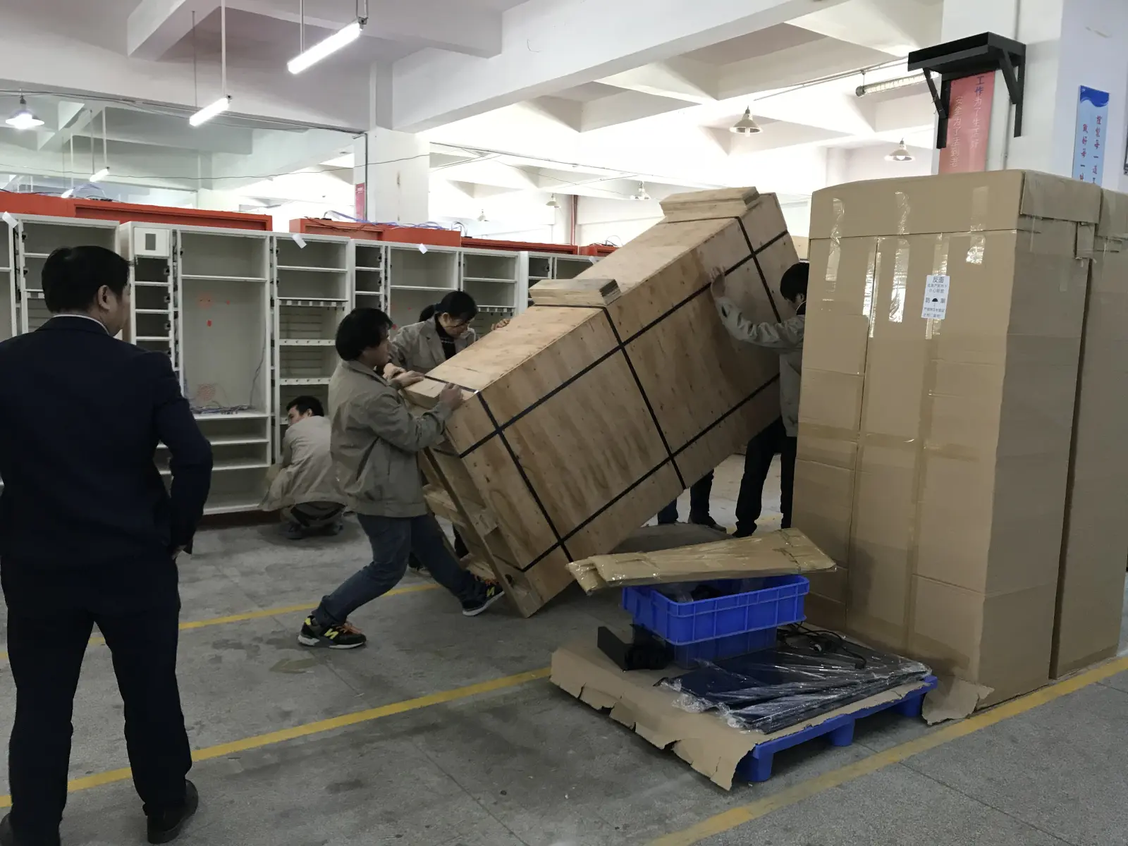 Factory workers packing the first locker for shipping to Beirut